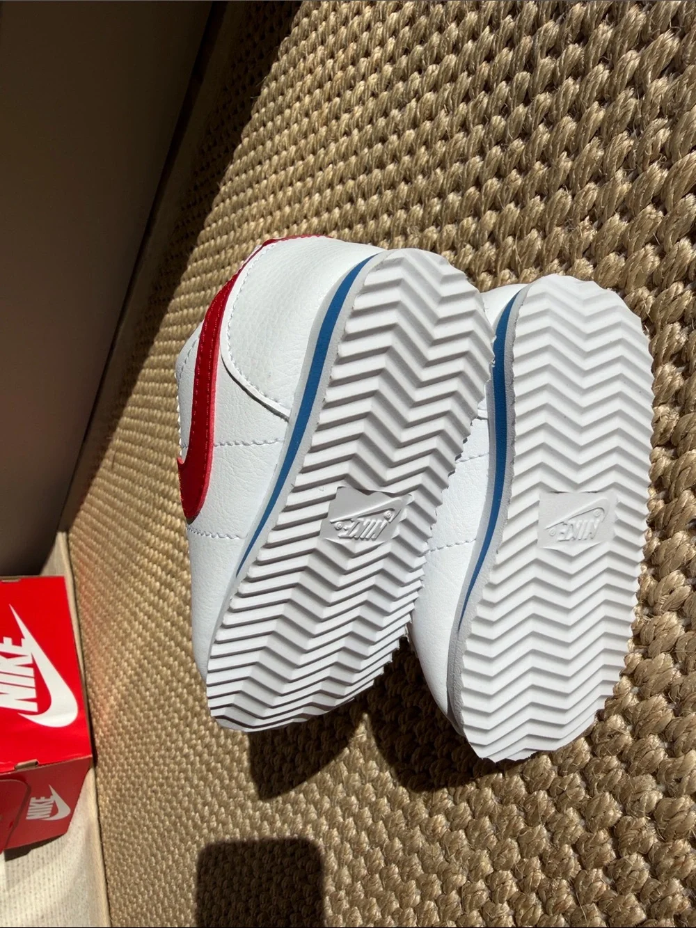 Nike White Baby Sneakers with Red Swoosh and Blue Accent size 4c